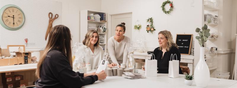 women sitting at table talking