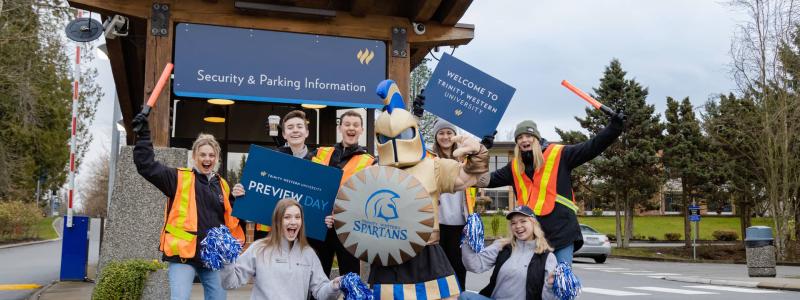 students welcoming outside with mascot