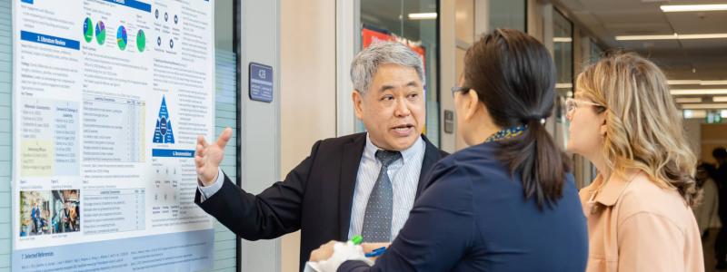 man presenting a research poster