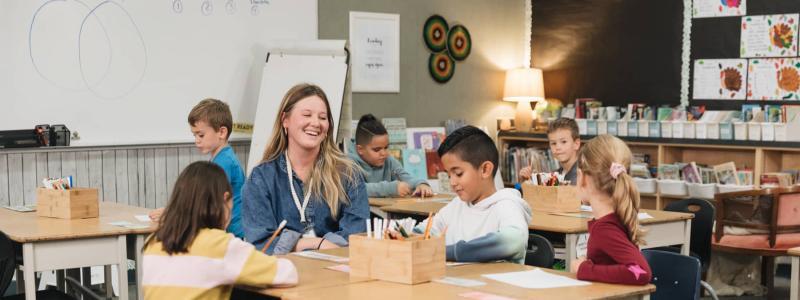 teacher working with students in classroom