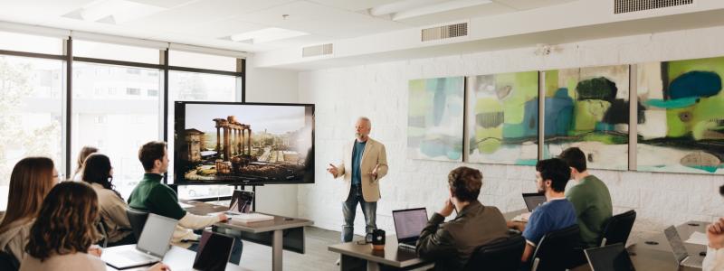 professor teaching history to students in class