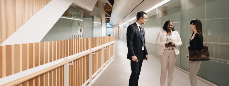 three business students talking in hallway