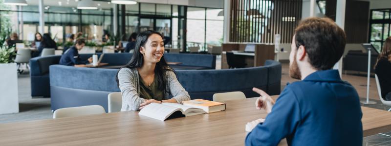 students sitting at a table and talking