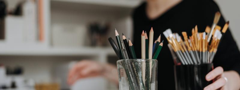 girl at table with art supplies
