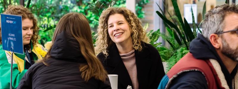 woman smiling and talking to person across table