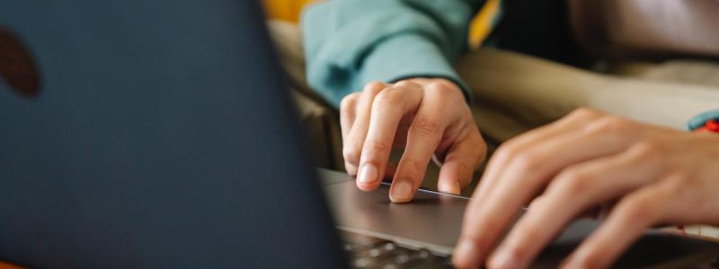 hands typing on computer