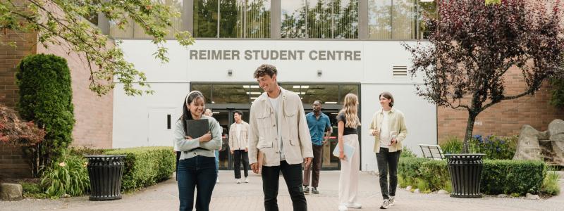 students standing outside in front of Riemer Student Centre