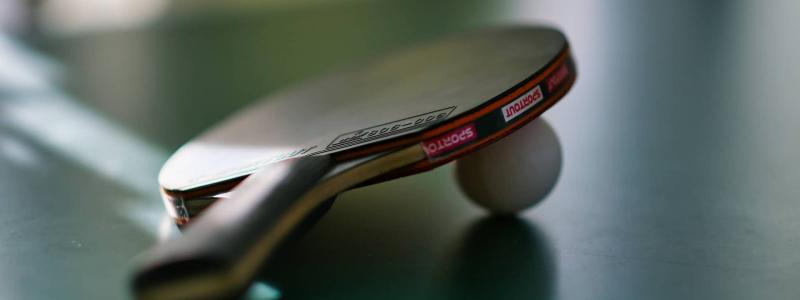 ping pong racket and ball on table