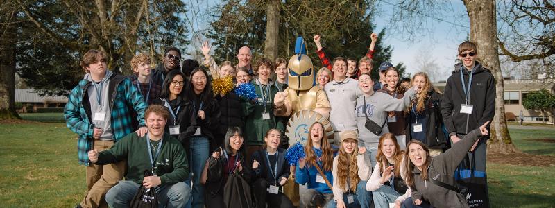 students and parents at preview day smiling with sparty