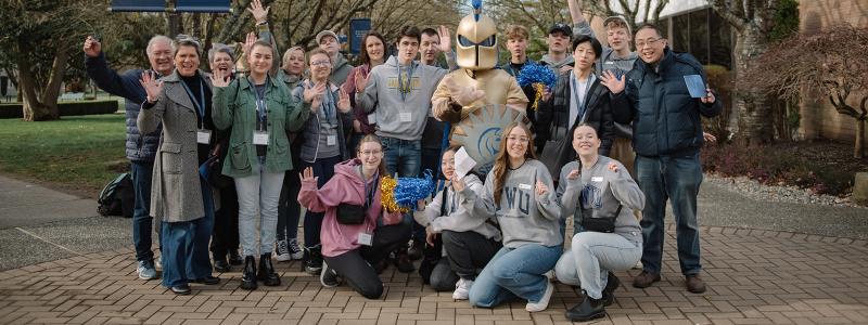 students and parents at preview day smiling with sparty