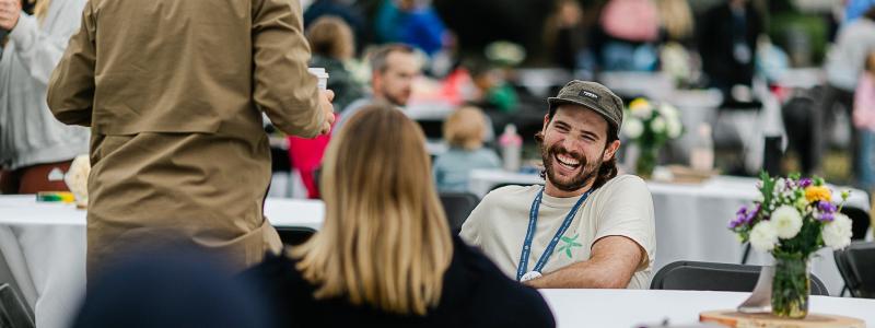 man sitting at table across from woman