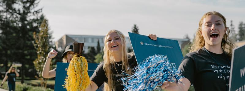students cheering at orientation for new students near university entrance