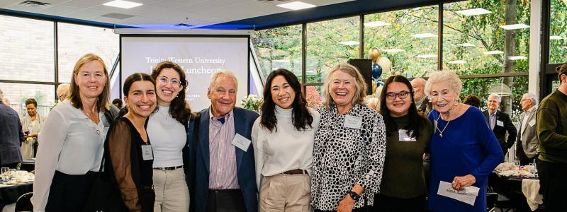 students and donors smiling as a group at a Legacy Luncheon 