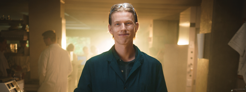 Spencer Funk standing in lab with light behind him