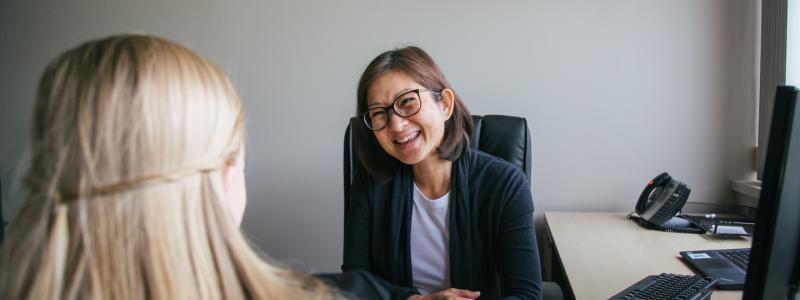 Woman sitting at a desk for an interview