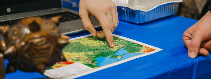 Hand pointing at a map