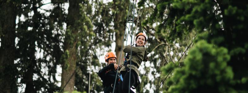 Two people on a rope course