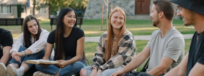 Students sitting on grass together