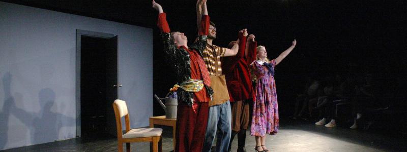 Actors holding hands to bow after a performance.