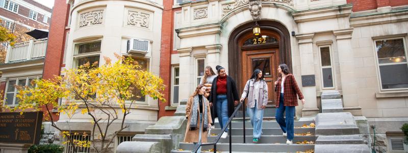 Students walking down the stairway of a building entrance