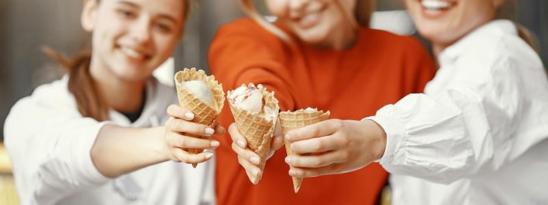 a group of girls holding icecream cones