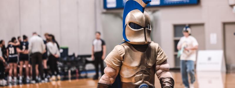 Basketball court with a Spartan mascot in costume.