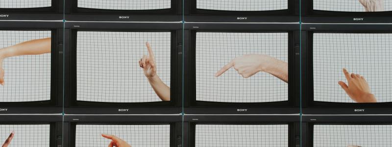 Multiple screens displaying different hands pointing in various directions.