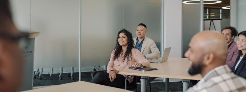 People smiling in a modern conference room.