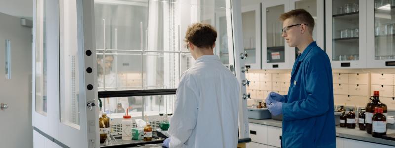 people working in a chemistry lab at TWU under a fume hood