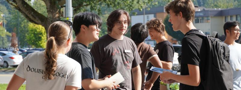 Students at a booth, talking.
