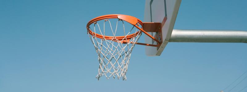 Photograph of basketball hoop with clear blue sky in the background