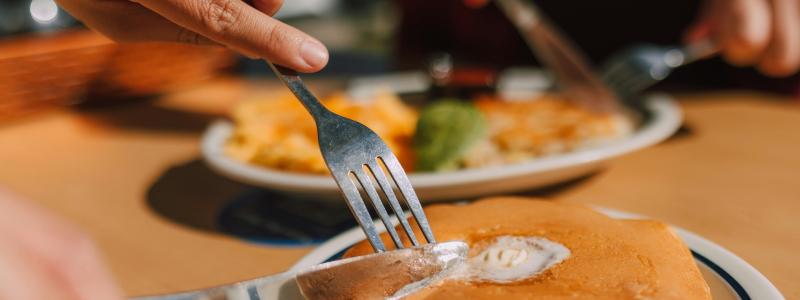 stock photo of people cutting pancakes