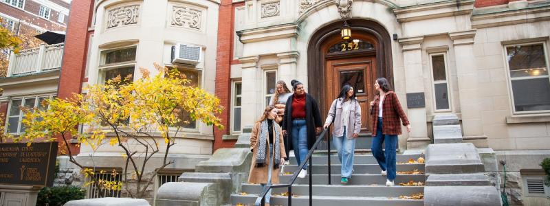 Students walking down the stairway of a building entrance