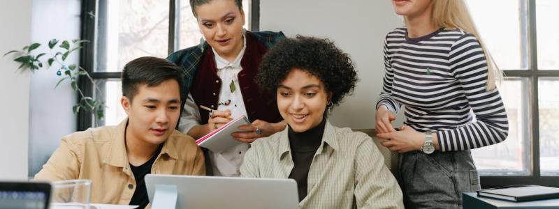 Group of people all staring at a computer
