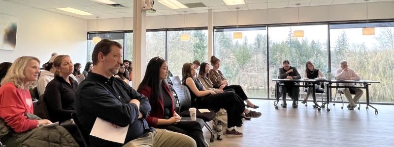 3MT 2026 audience with people sitting in a room with large windows