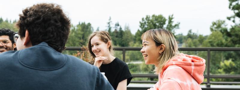 student sitting at table outside