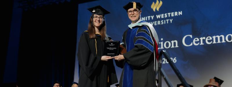 Jenessa Butler receiving a Valedictorian plaque from Rob Rhea