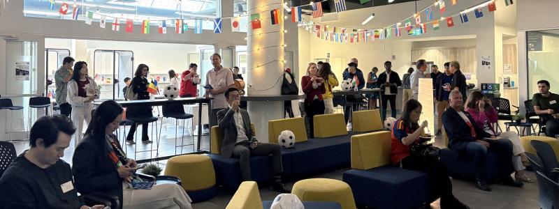 group of people in the Richmond campus with World Cup decorations around the room.