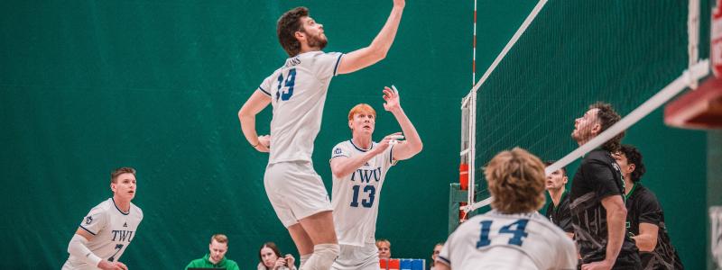 Men in white jersey playing volleyball in a court