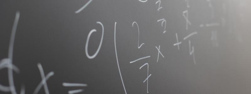 Mathematical formulas written on a classroom chalkboard.