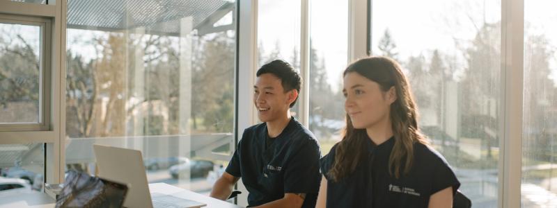 two school of nursing students in a classroom studying