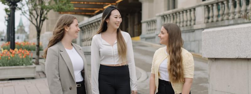 Three Laurentian Leadership Centre students walking and talking outside in downtown Ottawa.