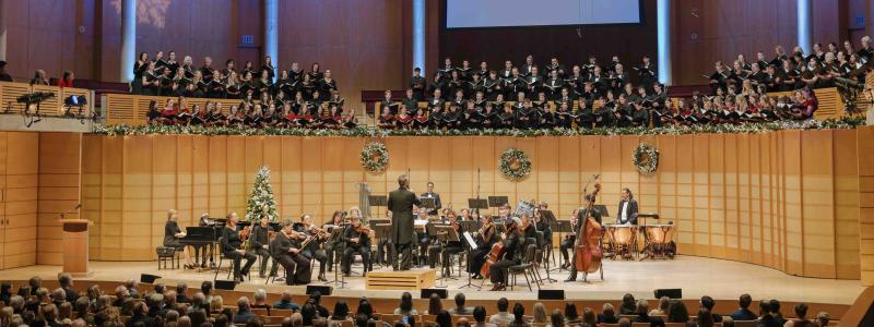 TWU choir and orchestra performing a holiday concert in a packed concert hall.