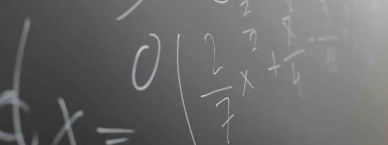Mathematical formulas written on a classroom chalkboard.