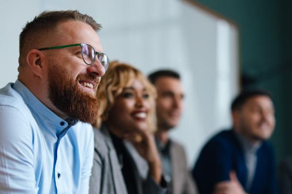 Smiling group of diverse professionals in a meeting room.