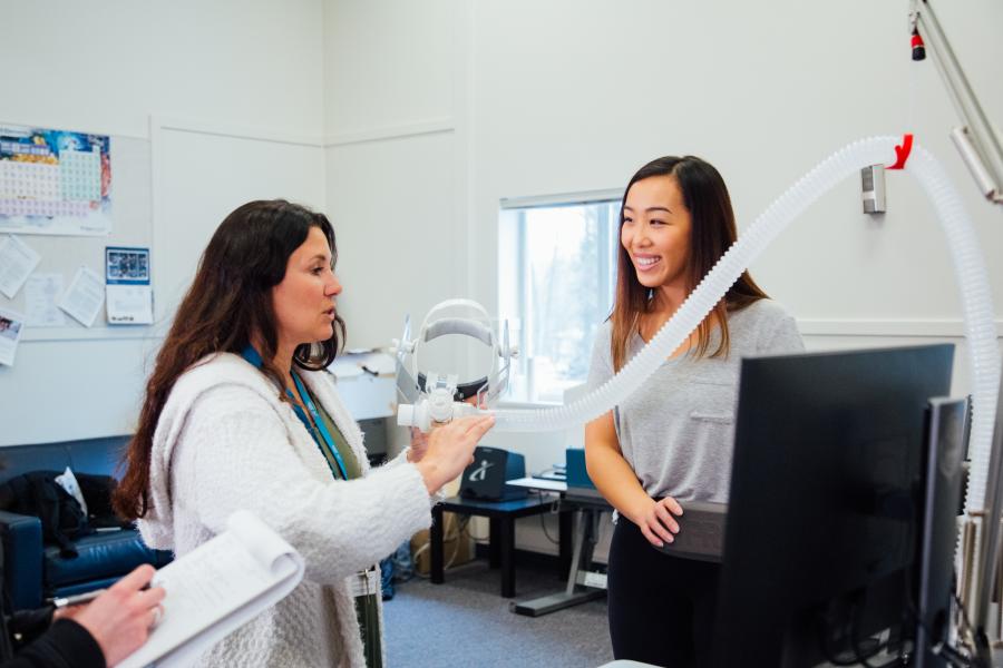 Student and instructor in lab with respitory equipment.