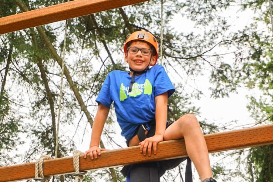 Young boy on the TWU Langley ropes course.