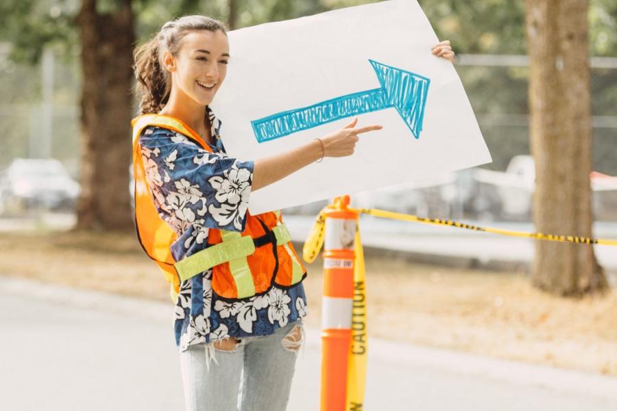 Student holding an arrow sign during O-week