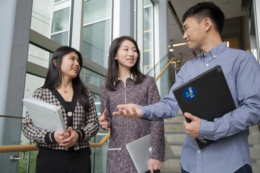 students talking while walking down the stairs