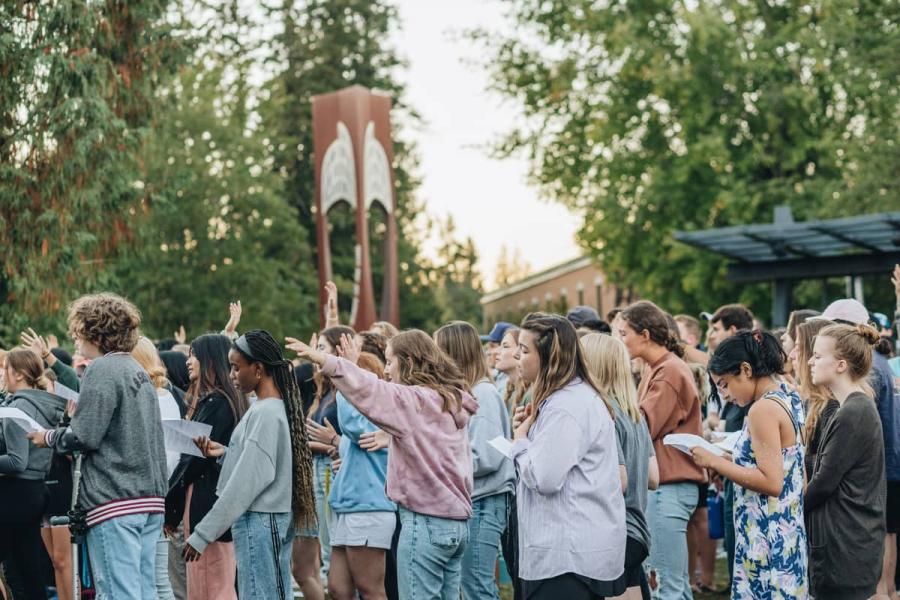 students worshiping outside
